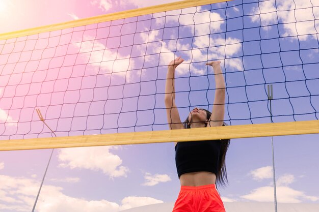 Young beautiful girl athlete in sportswear is training at the stadium