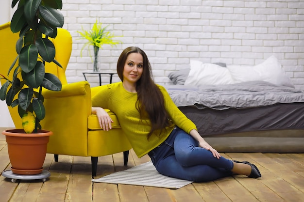 Young beautiful girl in casual clothes. The student prepares for the session.