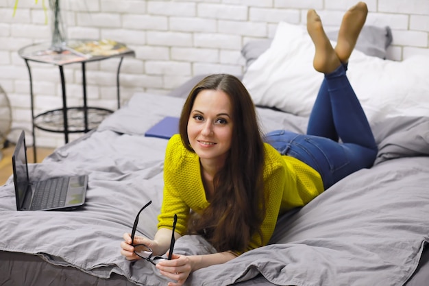 Young beautiful girl in casual clothes. The student prepares for the session.