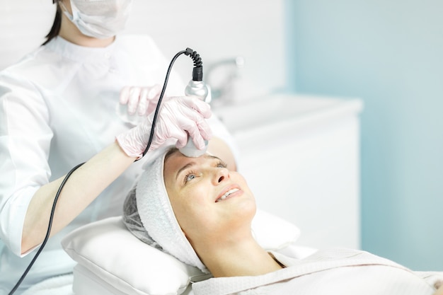 Young and beautiful girl in the clinic of natural beauty