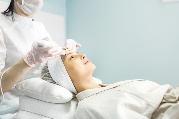 Young and beautiful girl in the clinic of natural beauty