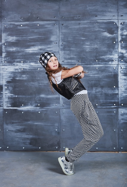 Young beautiful girl dancing in a trendy clothes