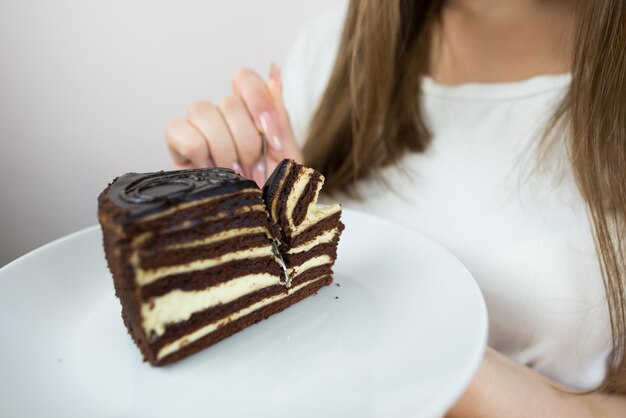 Young beautiful girl eating cake closeup crop photo womans mouth eating a piece of cake