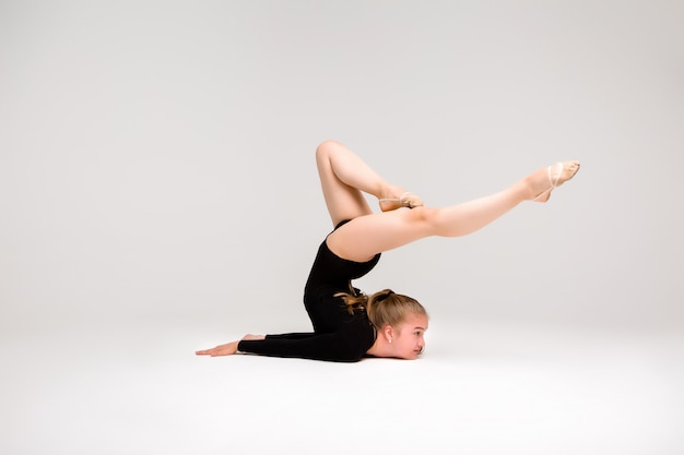 Young beautiful girl gymnast, a young girl is engaged in gymnastics