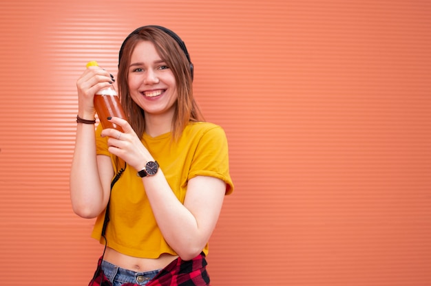 A young beautiful girl holding a plastic bottle