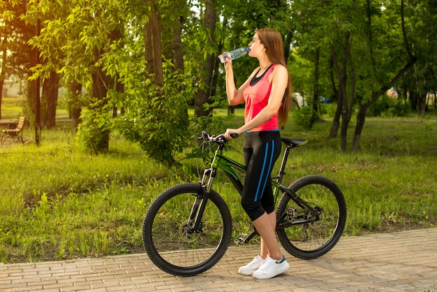 Young beautiful girl is drinking water