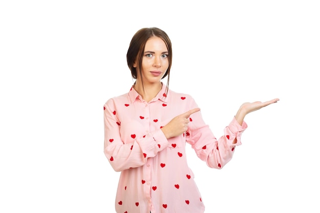 Photo young beautiful girl isolated on a white background points his fingers at the place for promo offers or advertising