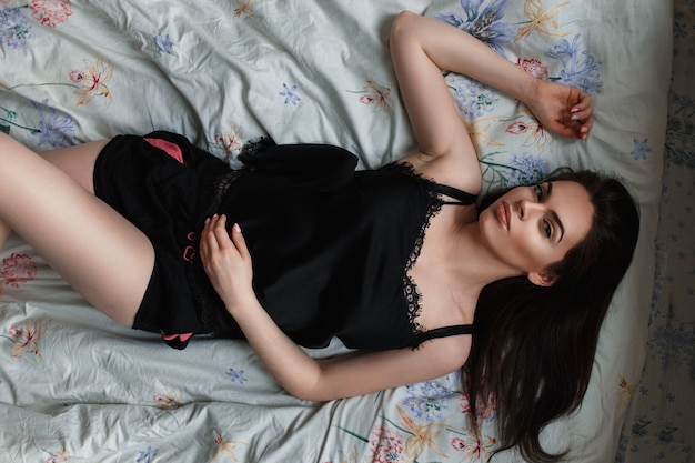 Young beautiful girl lying on the bed Top view