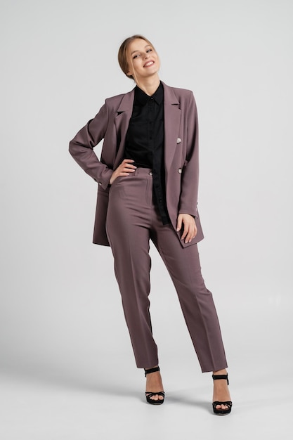 Young beautiful girl posing in a business suit Employee and business concept