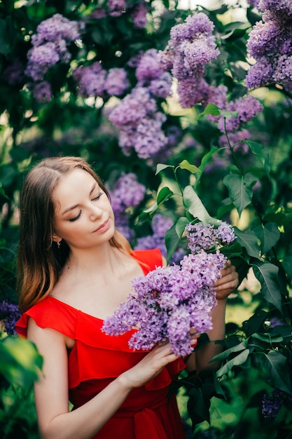 Young beautiful girl posing among the flowering tree