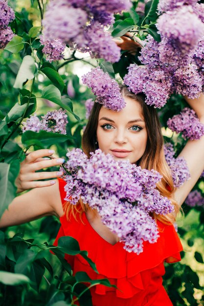 Young beautiful girl posing among the flowering tree