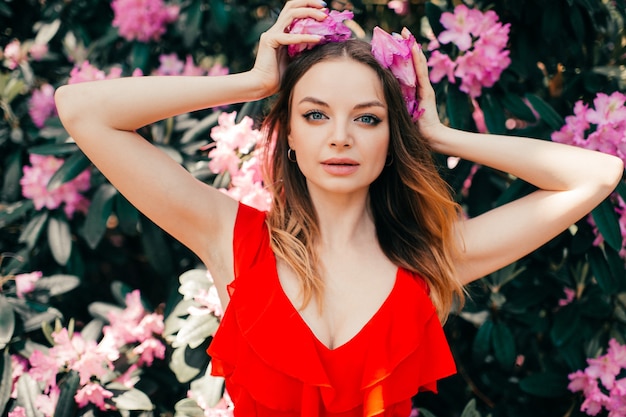 Young beautiful girl posing among the flowering tree