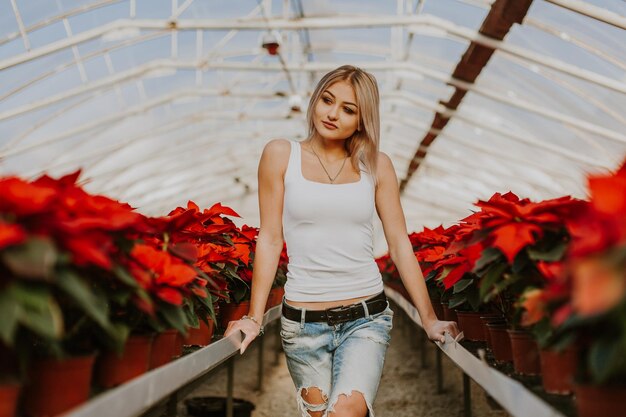 Young beautiful girl in the red flowers