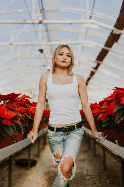 Young beautiful girl in the red flowers