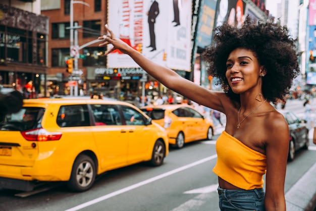 Young beautiful girl walking in Time square, manhattan. Lifestyle concepts about New york