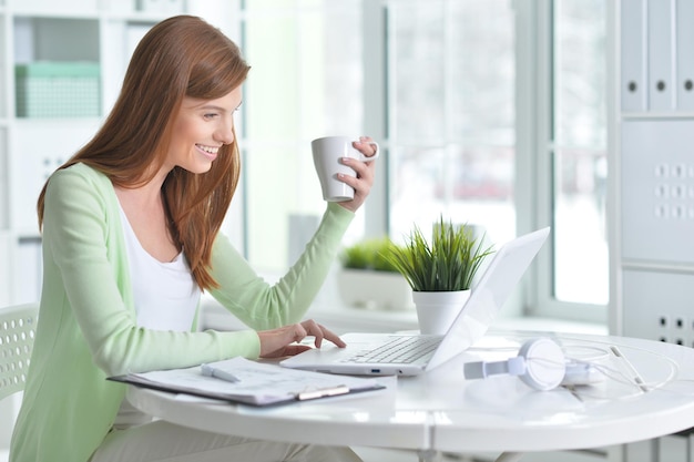 Young beautiful girl working at a laptop