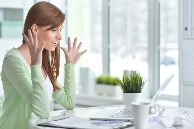 Young beautiful girl working at a laptop