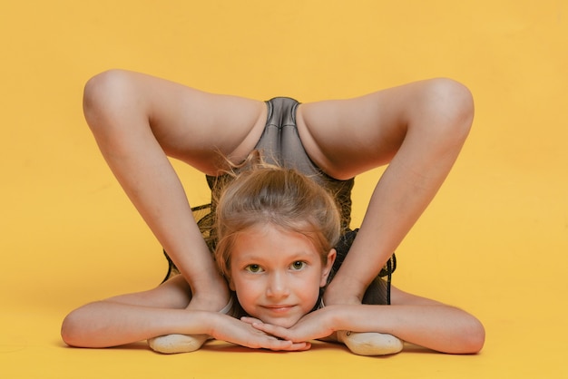 Young beautiful gymnast in sportswear performs a handstand Workout gymnastics element