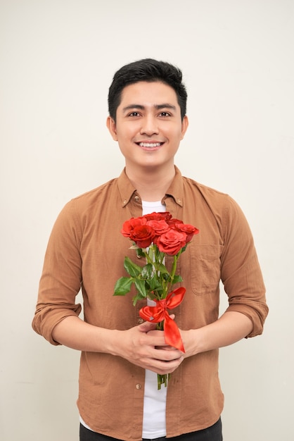 Young beautiful handsome attractive enamored man casual style with flowers