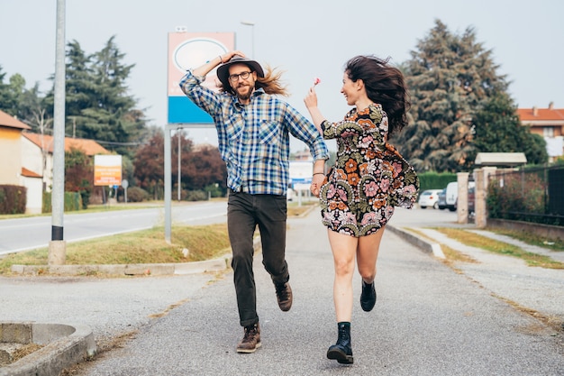 Young beautiful happy couple running outdoor