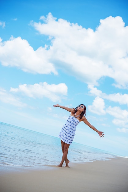 Young beautiful happy woman enjoying the beach