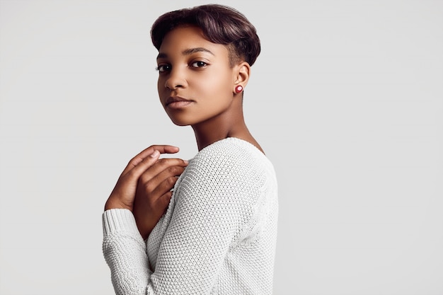 Young beautiful hipster black girl with short hair in white sweater