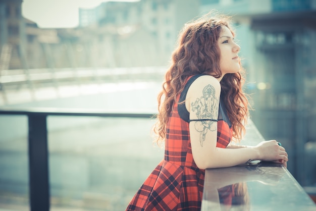 young beautiful hipster woman with red curly hair