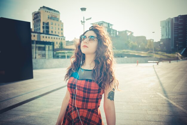 young beautiful hipster woman with red curly hair