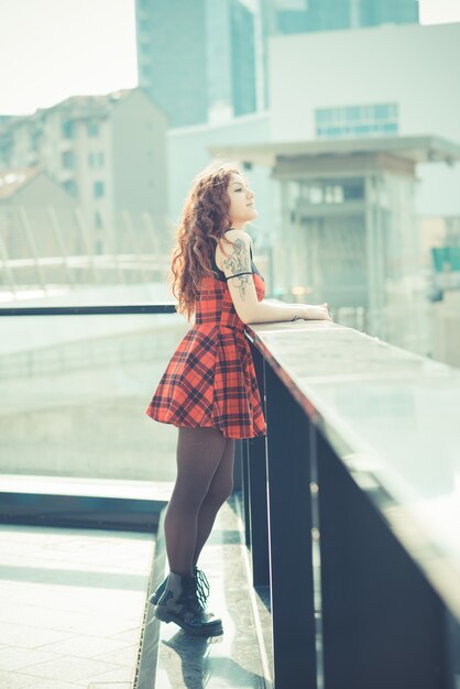 Young beautiful hipster woman with red curly hair