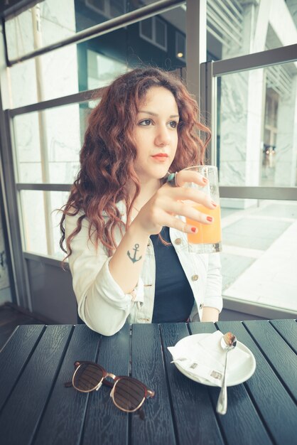 young beautiful hipster woman with red curly hair