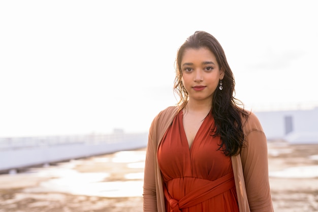 Young beautiful Indian woman at rooftop of the building