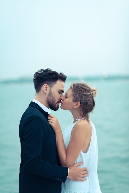 Young beautiful married couple embracing on the yacht on vacation