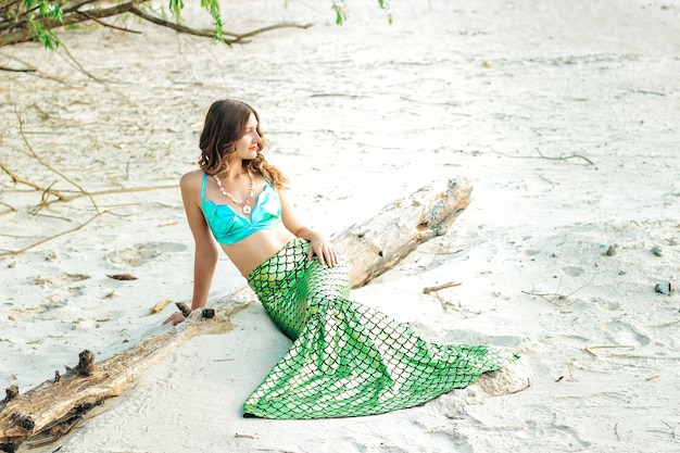 Young beautiful mermaid woman close up standing on the sea cost. Cosplay mermaid.