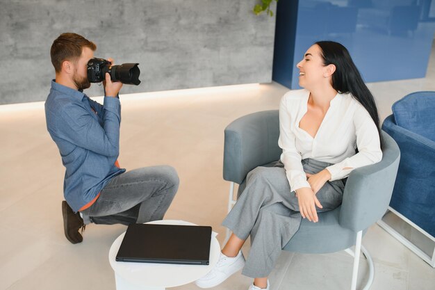 Young beautiful model posing for professional photographer in studio