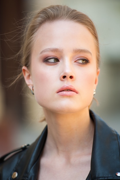 Young beautiful modern woman outdoors with expressive makeup