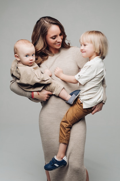 Young beautiful mothe keeping two cute children