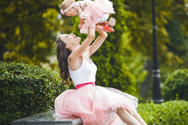 Young beautiful mother with her little baby daughter