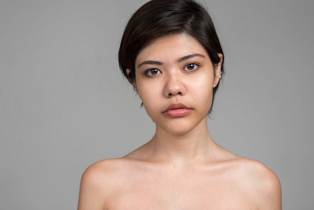 young beautiful multi ethnic teenage girl with short hair shirtless