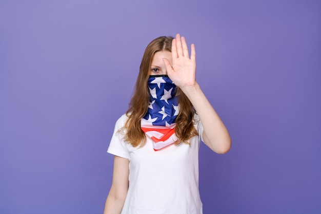 Young beautiful patriotic woman wearing United States flag face mask