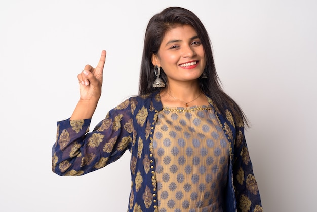 Photo young beautiful persian woman wearing traditional clothing against white wall