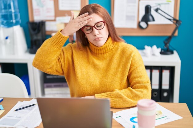 Young beautiful plus size woman business worker stressed using laptop at office