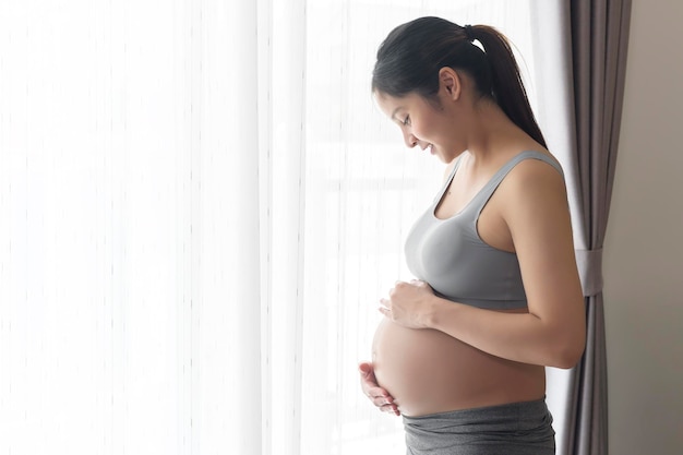 自宅で若い美しい妊婦出産と妊娠ケアのコンセプト
