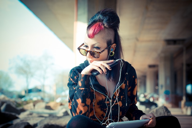 young beautiful punk dark girl using tablet