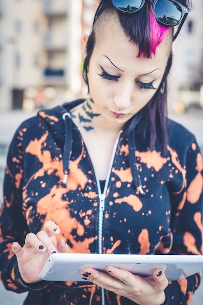 young beautiful punk dark girl using tablet