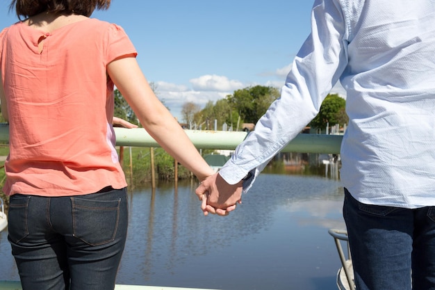 Young beautiful romantic couple outdoors in front of the river