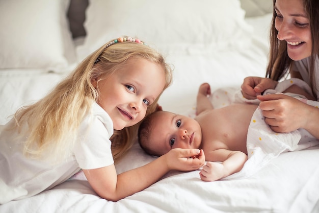 Young beautiful sister holds a baby