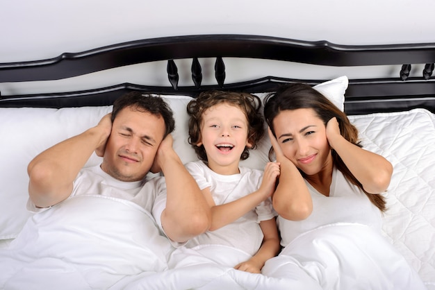 Young beautiful Sleeping family with the little son.