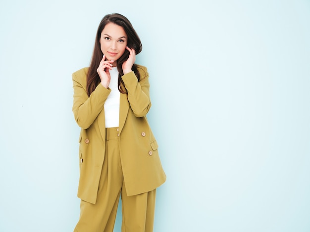 Young beautiful smiling female in trendy summer clothes