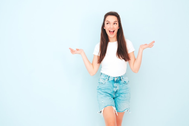 Young beautiful smiling female in trendy summer hipster clothes