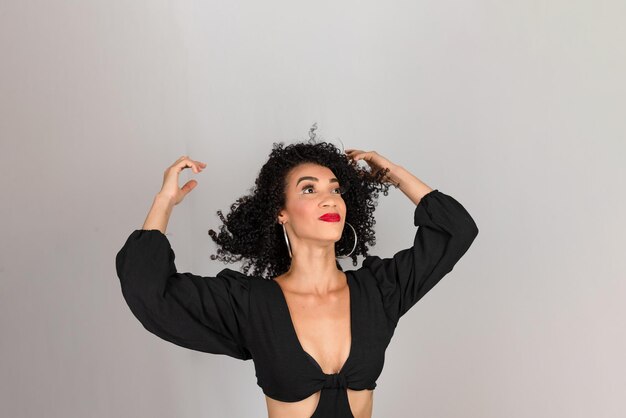 Young beautiful smiling woman with her hand in her hair looking up isolated on white background in studio person